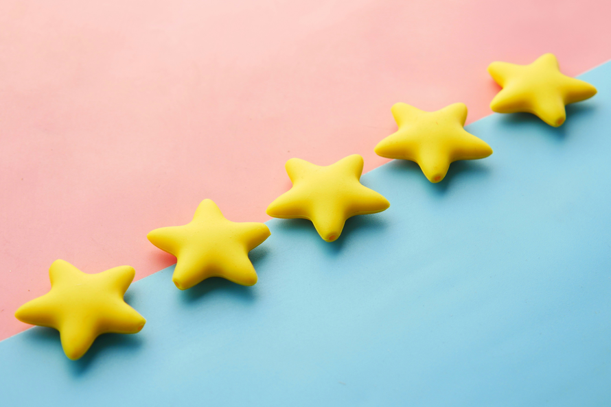 five gold stars on pink & blue background