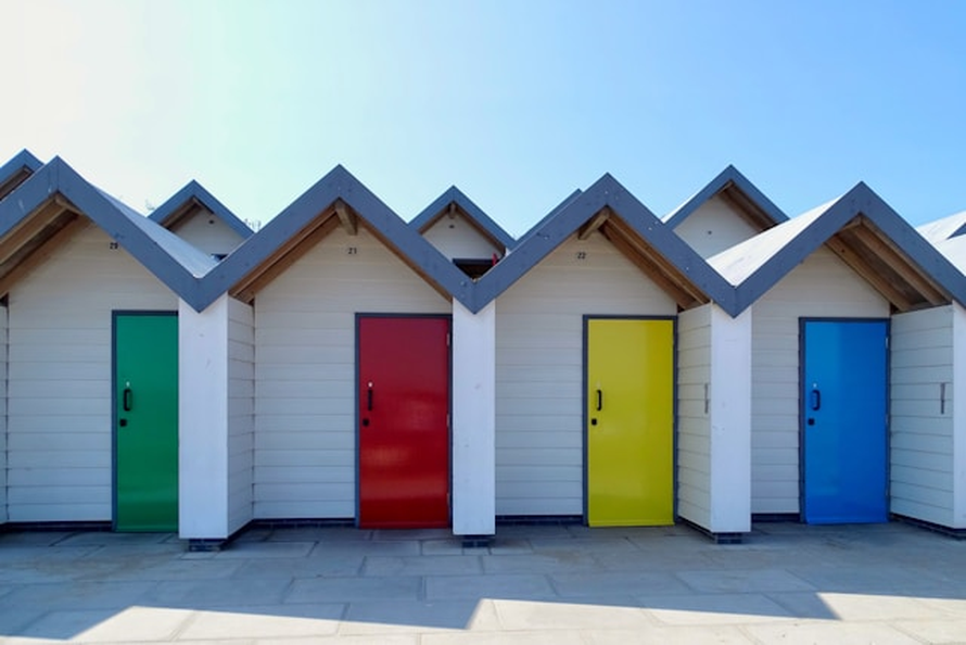 Colourful beach huts along the seafront at Swanage Dorset.